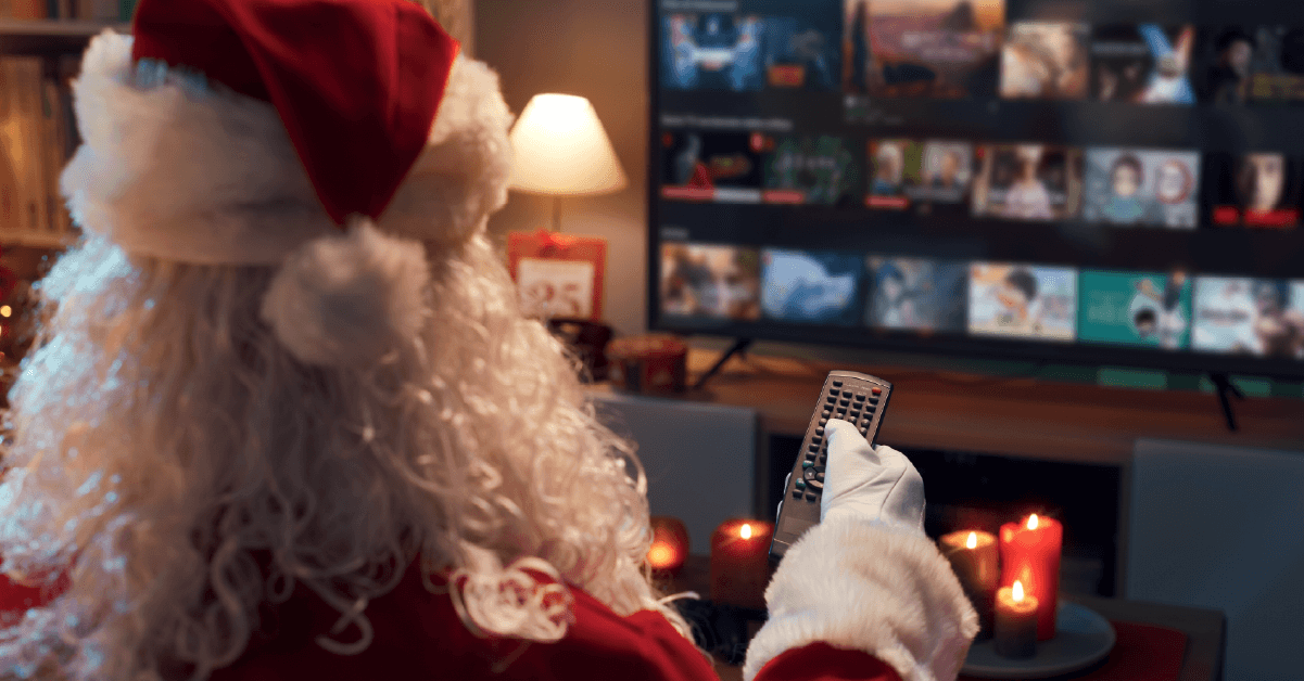Santa holding a tv remote during the holiday season